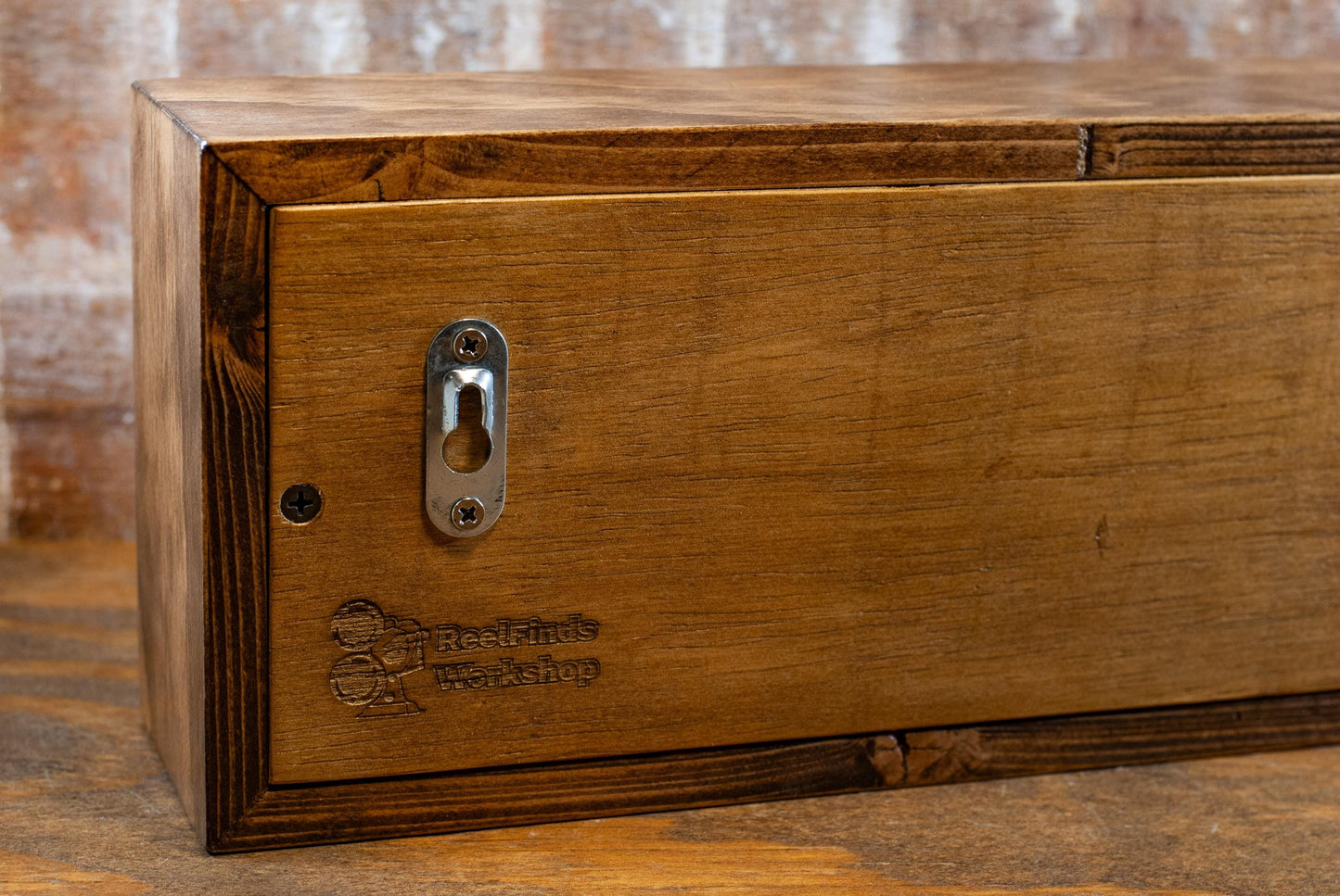 back view of a chestnut brown LED lightbox sign on a wooden desk of a studio room