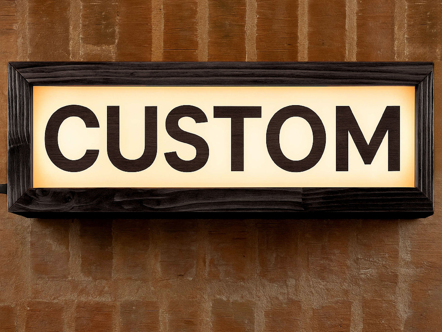 black wooden custom LED lightbox sign hanging on the wall of a recording studio