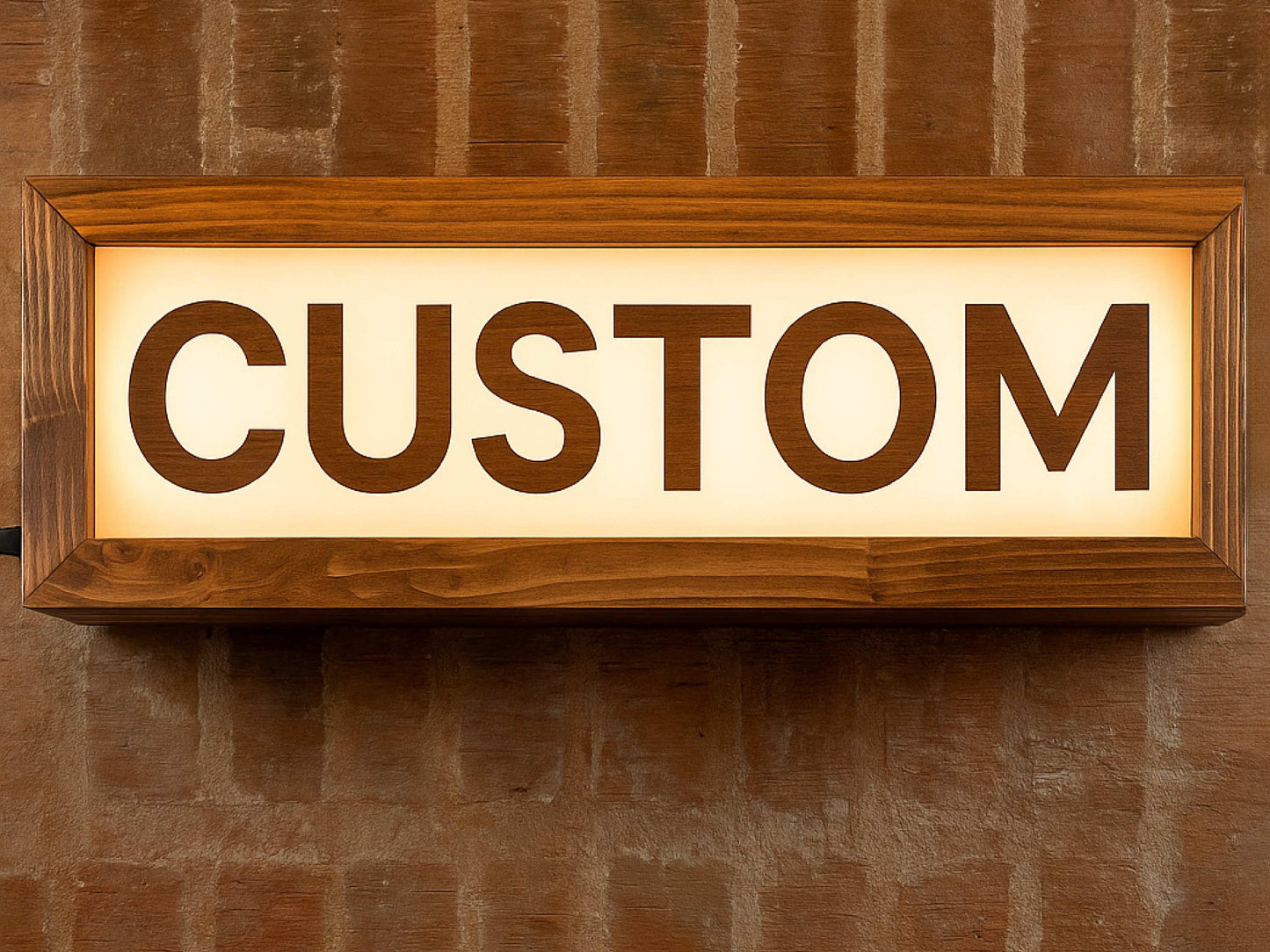 chestnut brown wooden LED lightbox sign that reads CUSTOM hanging on wall of a recording studio