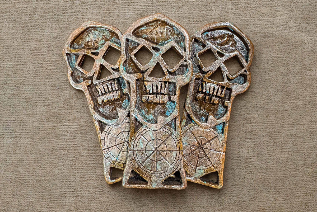 Three copper bones skeleton keys on burlap fabric background