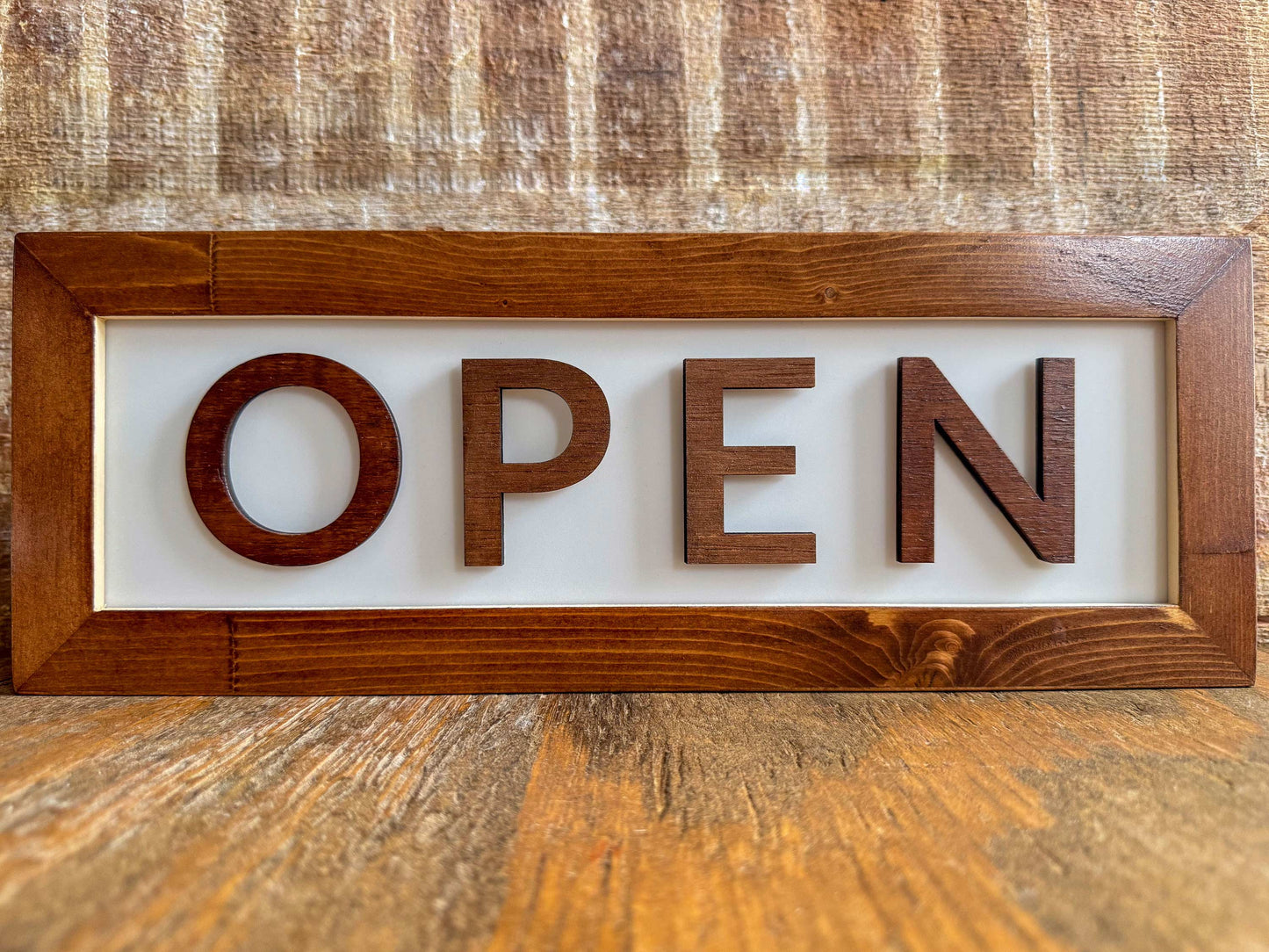 chestnut brown OPEN LED Lightbox sign for business sitting on wooden desk