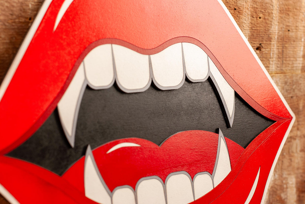 gothic wall art red lips with fangs on a wooden background