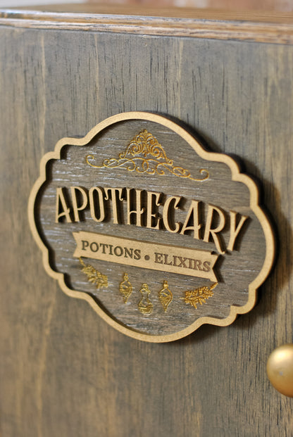 Close-up view of rustic apothecary box with wooden sign that reads 'Apothecary Potions & Elixirs'.