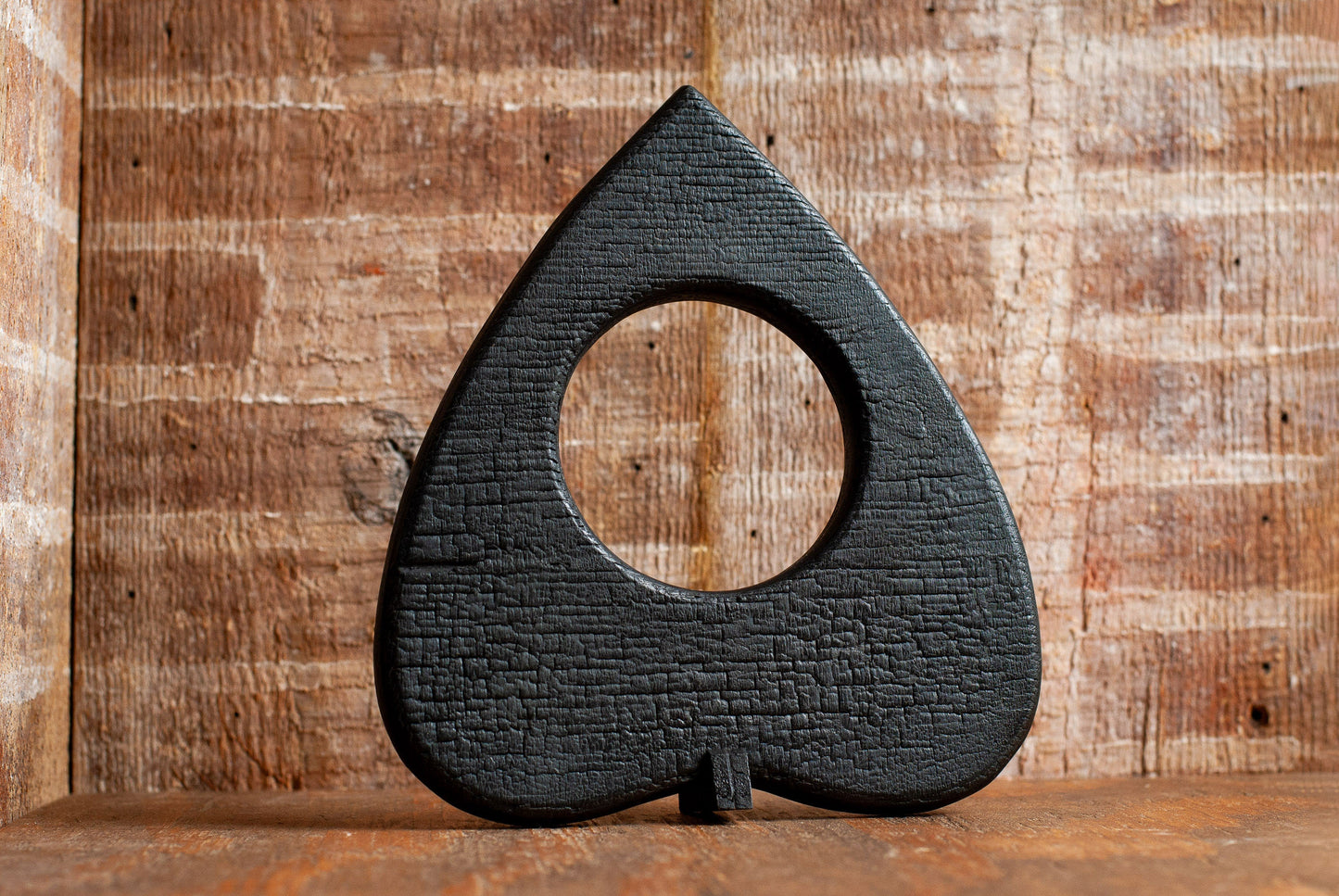 Front view of Torched Wooden Black Planchette | Ouija Planchette Wall Decor or Halloween Prop with Stand | Gothic Wall Art | Unique Horror Decor | Spooky Gifts