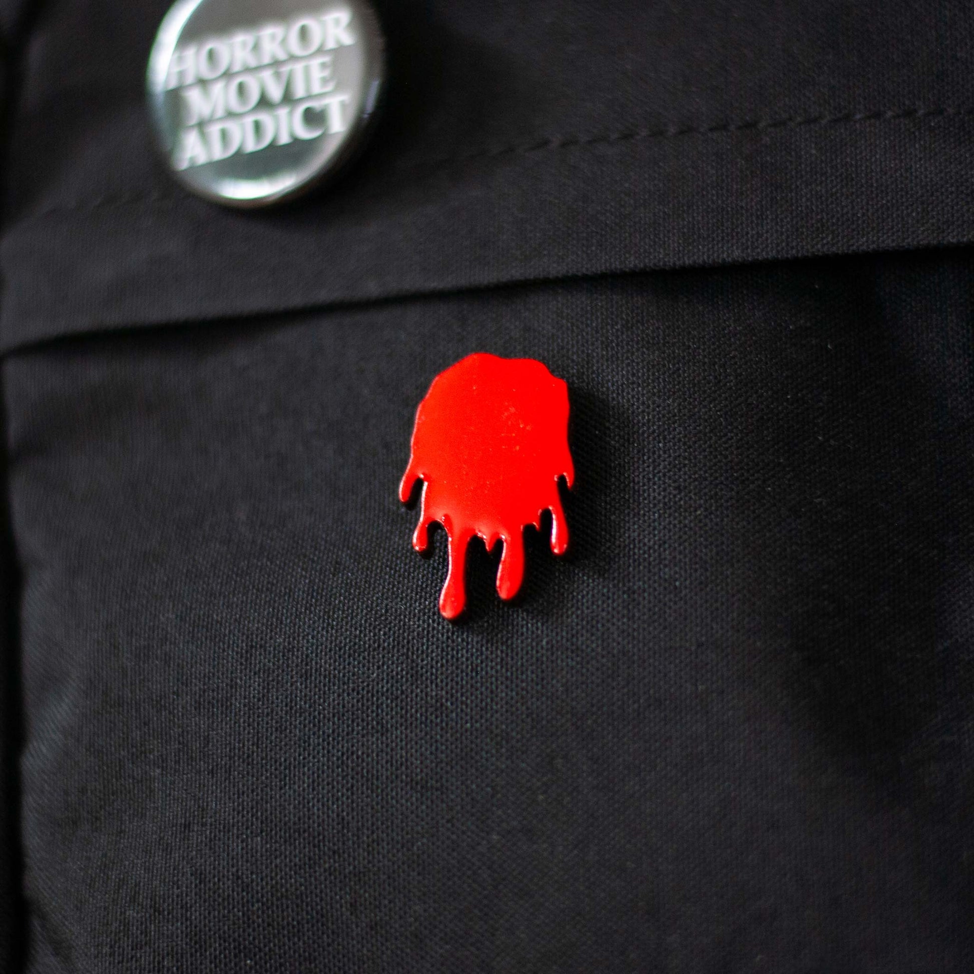 Red blood drip brooch pin on a black bag 