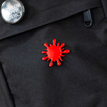 Blood red splatter brooch pin on black bookbag