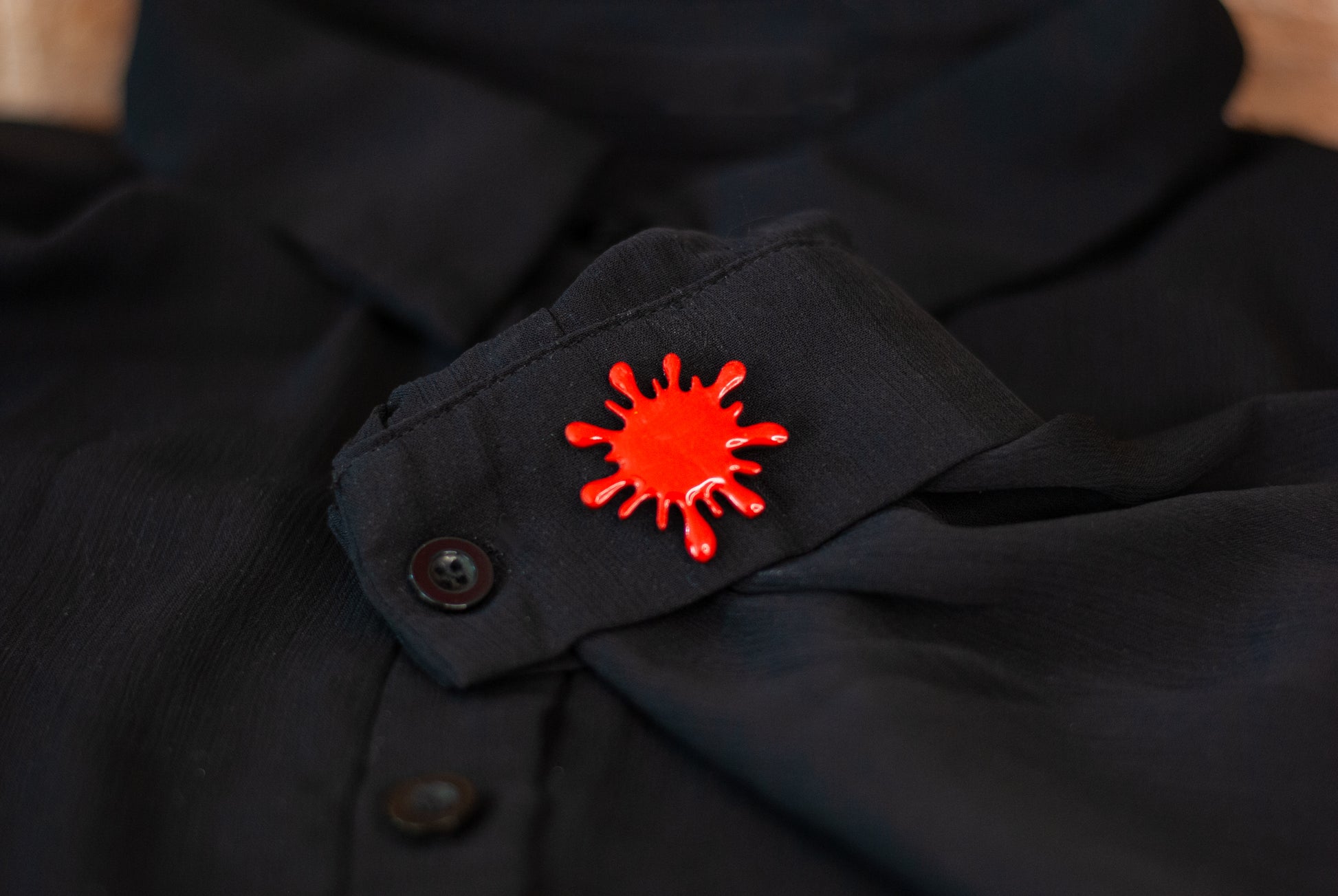 Blood red splatter brooch pin on black sheer shirt