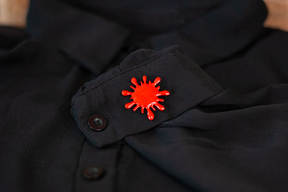 Blood red splatter brooch pin on black sheer shirt
