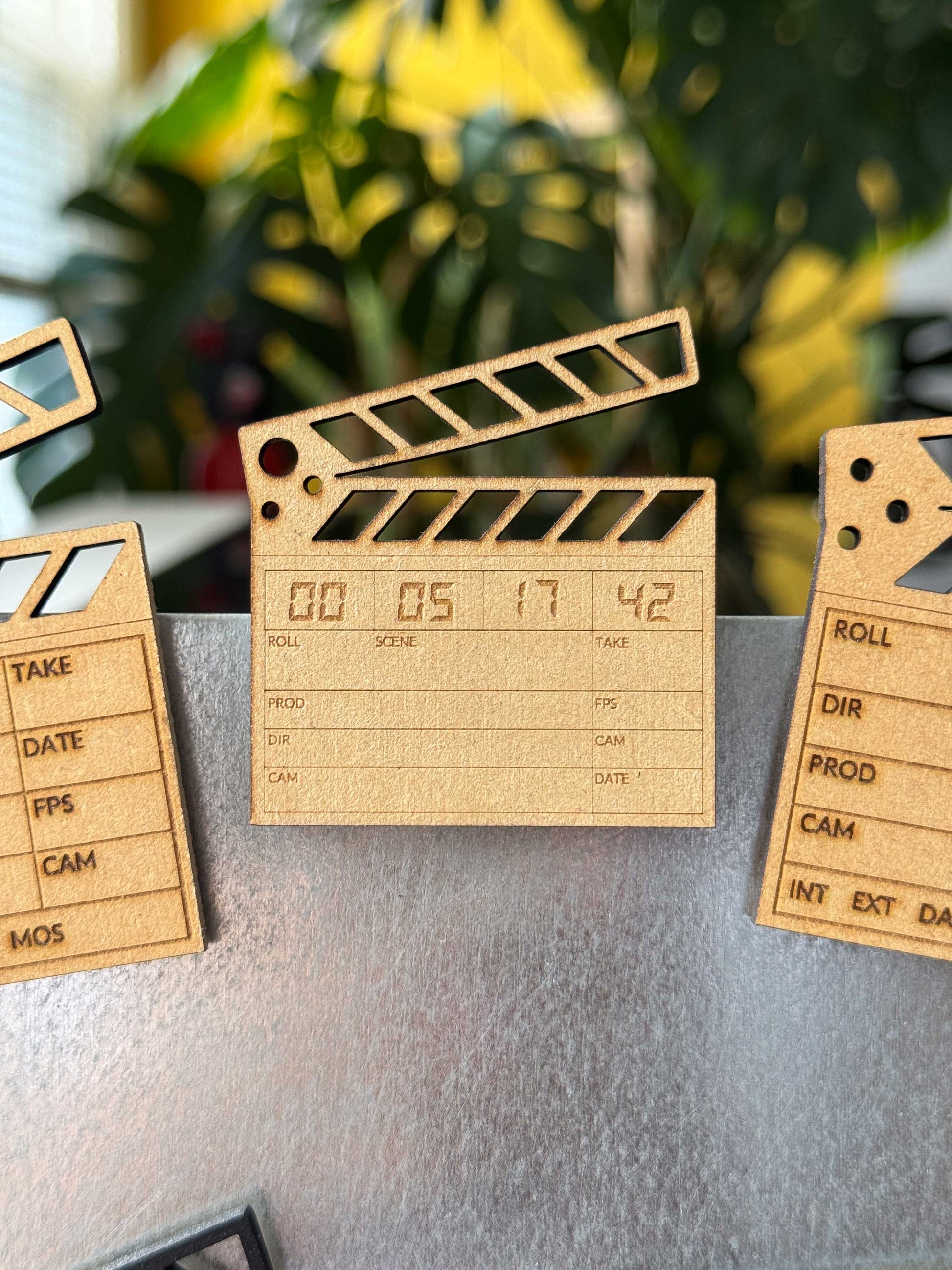 custom engraved wooden clapboard magnet with a personalized timestamp on a fridge