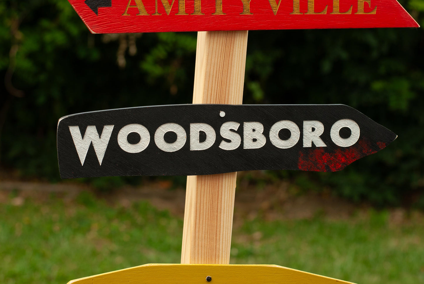 Close up of Woodsboro Horror Decor Directional Signs with Post and stand outdoor Halloween decoration with six horror destination signs - Movie Room Decor