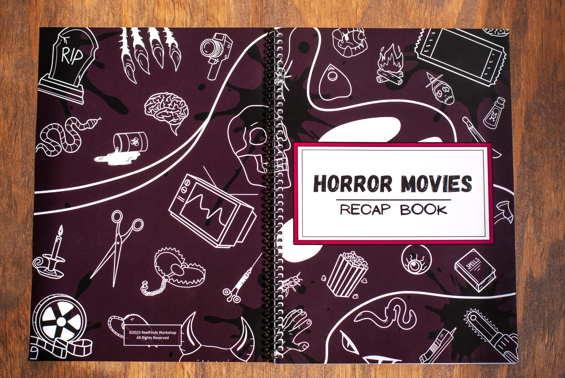 full detail cover of Horror Movies Recap Book spiral notebook movie review journal with spooky design on a wooden table