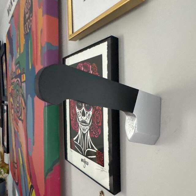wooden knife wall hook hanging on spooky gallery wall