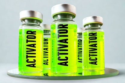 Five Activator prop glass vials filled with bright green substance on a reflective surface