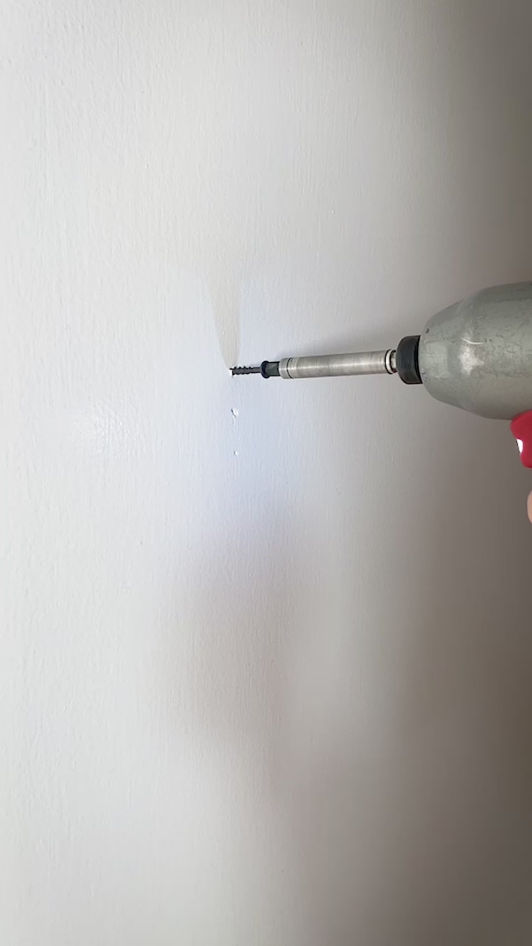 wooden knife-shaped wall hook being setup with drill into wall